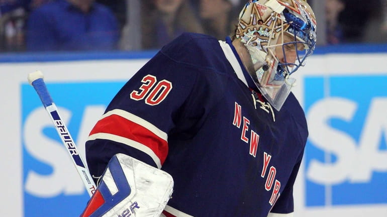 Henrik Lundqvist reacts after allowing a goal to Boston Bruins...