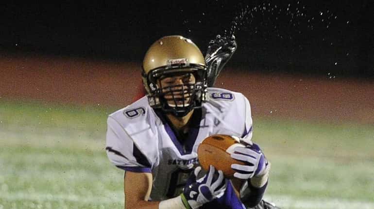 Sayville wide receiver Jake Sichenzia completes the reception from quarterback...