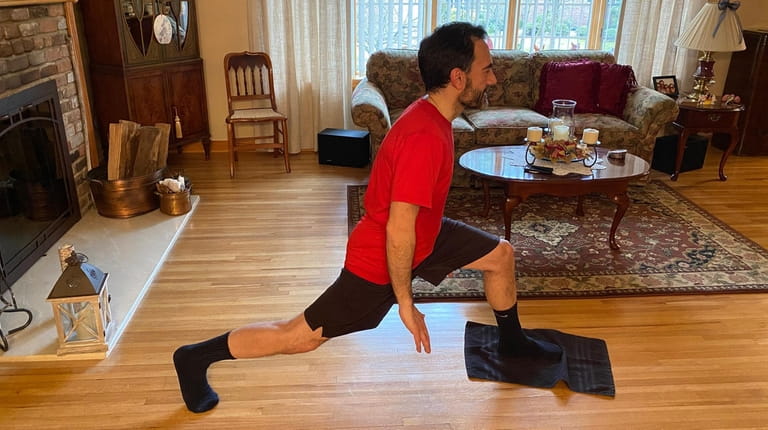 John Lalena works out at home in Port Washington. "I'm continuing...