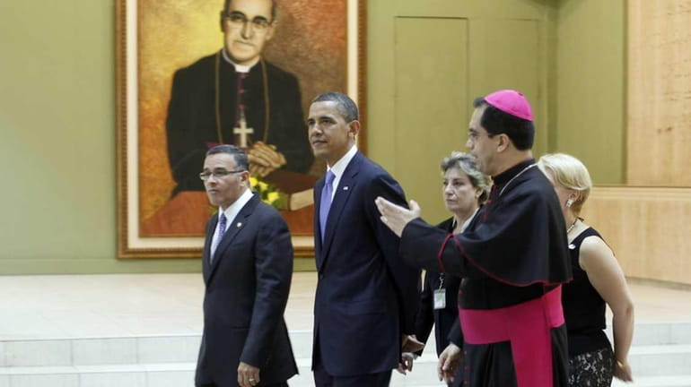 President Barack Obama, center, with Monsignor Jose Escobar, right, and...