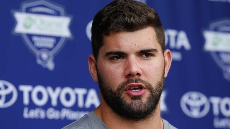 Justin Pugh of the Giants speaks to the media before...