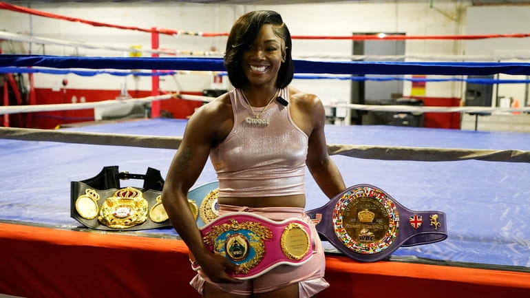 Claressa Shields poses with her prize belts after an interview,...