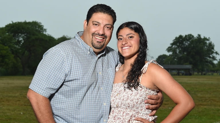 Sophia Diaz, Massapequa softball pitcher, with her father, Frank Diaz,...