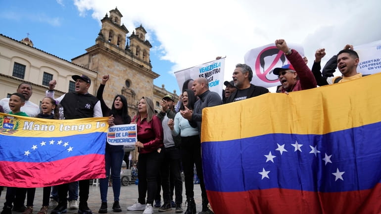 Venezuelans, who support opposition leader María Corina Machado, sing their...