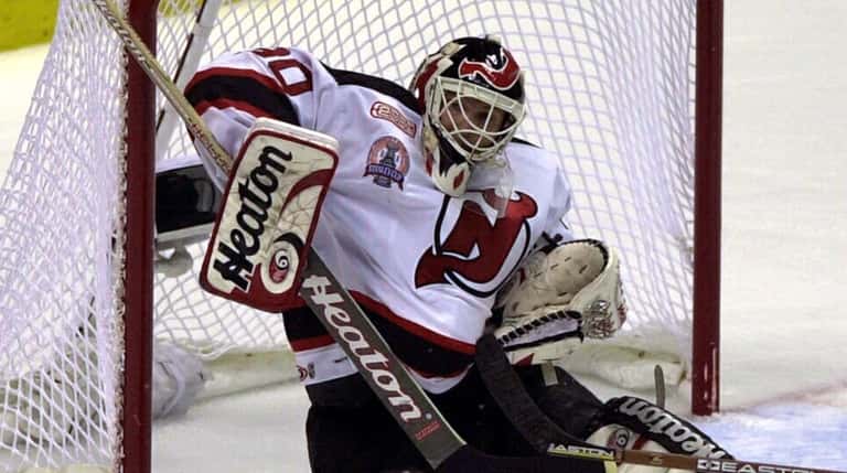 New Jersey Devils goalie Martin Brodeur makes a save against...
