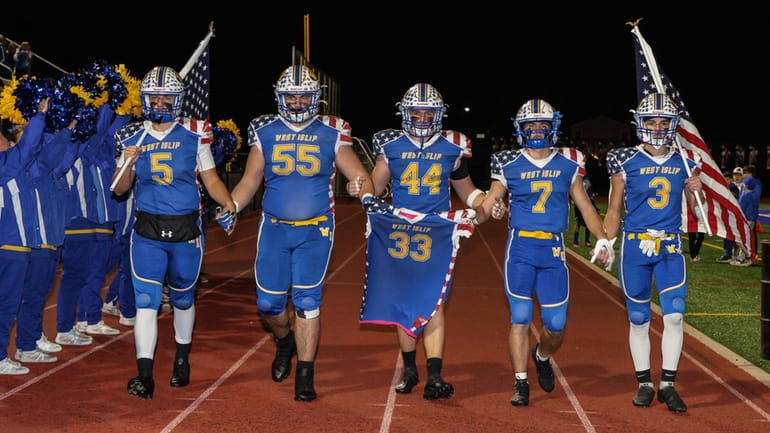 The West Islip captains honor Kyle Dilegame before a Suffolk...