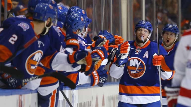 Kyle Okposo #21 of the New York Islanders celebrates his...
