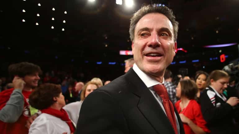 Louisville head coach Rick Pitino celebrates after beating Syracuse in...