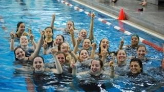 Ward Melville swimmers and coaches jump in the pool to...