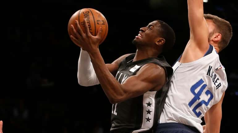 Caris LeVert of the Nets goes to the hoop for a...