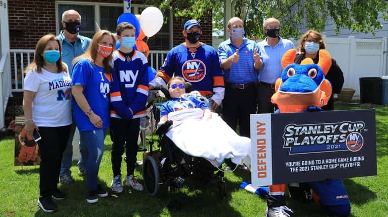 Islanders co-owner Jon Ledecky, third from right, visits 8-year-old Madison...