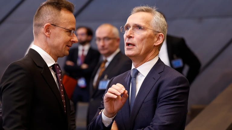 NATO Secretary General Jens Stoltenberg, right, speaks with Hungary's Foreign...