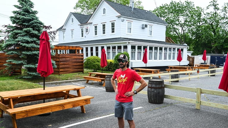 Justin Tempelman, owner of JT's Farmhouse, in Bayport, stands in...