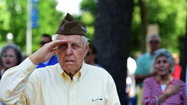 World War II veteran James A. Gray salutes the flag...