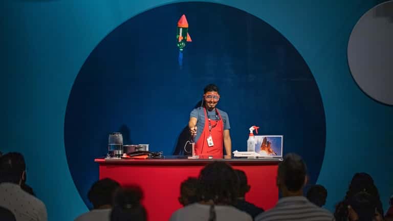 A staff "Science Explainer" gives a scientific demonstration at the...