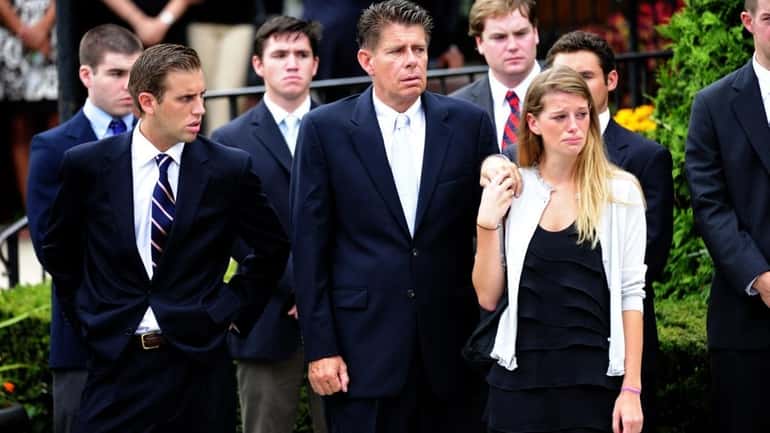James and Daphne Malone, front, attend the funeral for Paige...