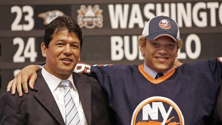 Kyle Okposo, right poses for a photo with Islanders head...