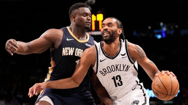 Keita Bates-Diop of the Nets is guarded by Zion Williamson of...