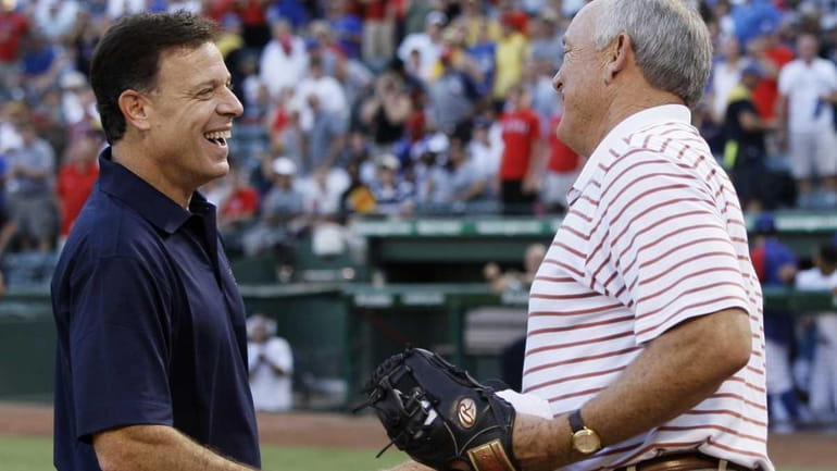 Texas Rangers co-owner Chuck Greenberg, left, shakes hands with team...