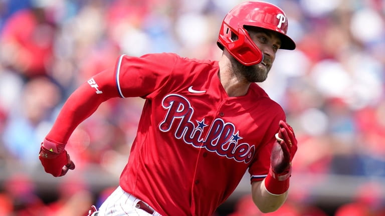 The Phillies' Bryce Harper runs after hitting a double during...