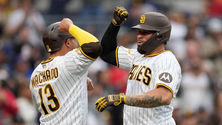 San Diego Padres' Gary Sanchez, right, celebrates with teammate Manny...