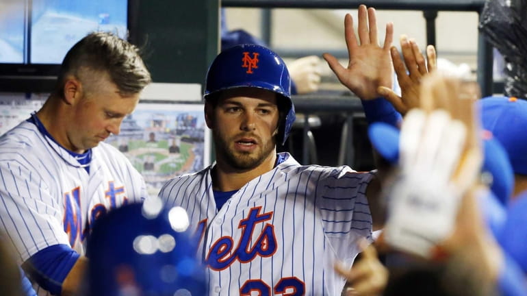 Kevin Plawecki of the New York Mets celebrates after scoring...