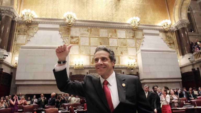 New York Gov. Andrew Cuomo reacts after same sex marriage...