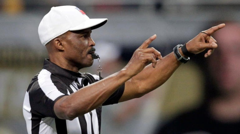 Referee Mike Carey makes a call during the second quarter...
