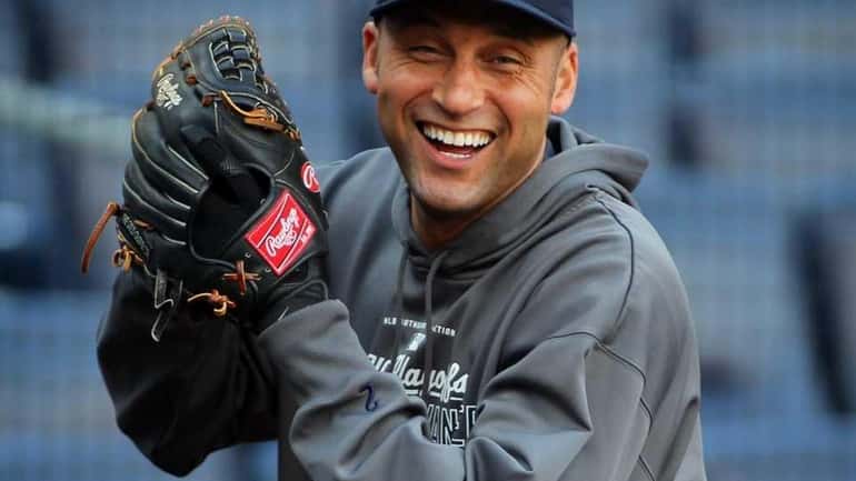 Derek Jeter laughs while warming up for an ALCS game...