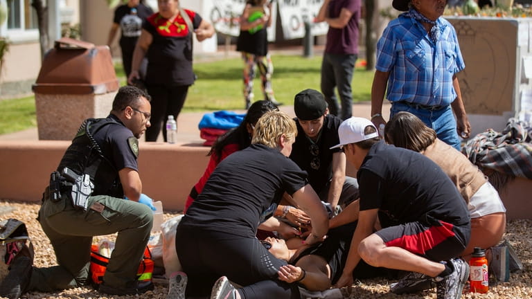 Activists tend to a shooting victim during a protest where...