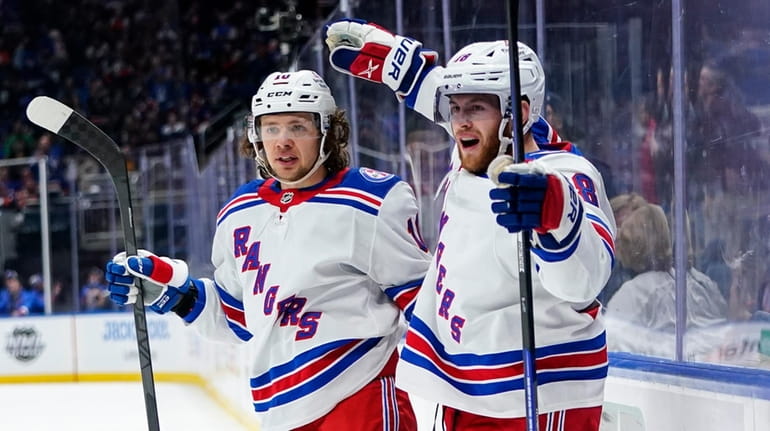 The Rangers' Andrew Copp, right, celebrates with Artemi Panarin after...