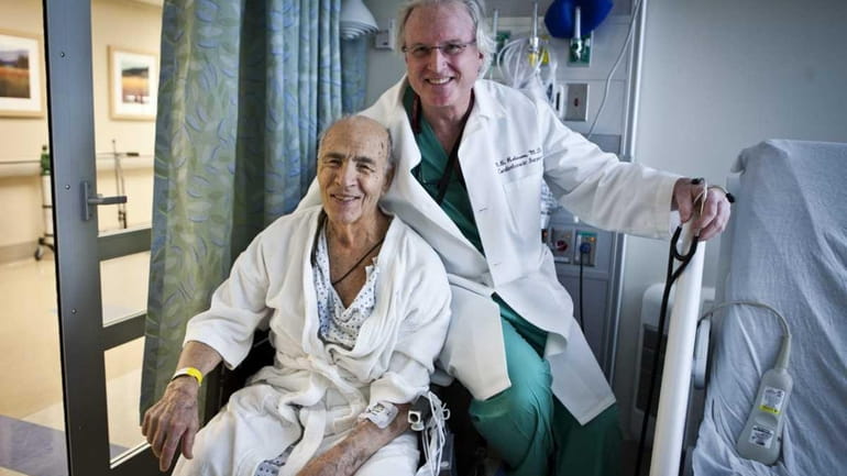 Dr. Newell Robinson smiles with Anthony Leto, 92, after he...