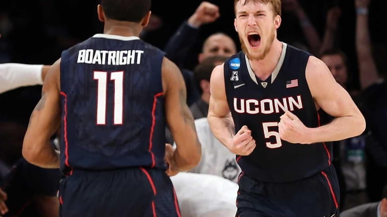 Niels Giffey of the Connecticut Huskies reacts after hitting a...