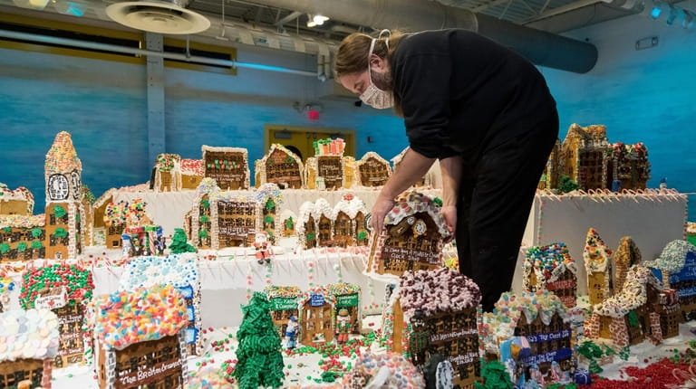 Jon Lovitch, artist and creator of GingerBread Lane, touches up his...