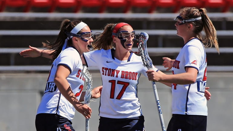 Stony Brook's Kylie Ohlmiller #17 is congratulated by her sister...