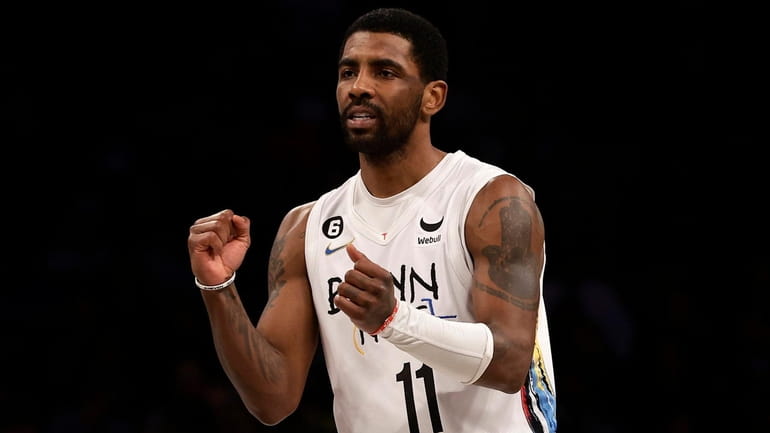 Kyrie Irving of the Nets reacts after a basket in...