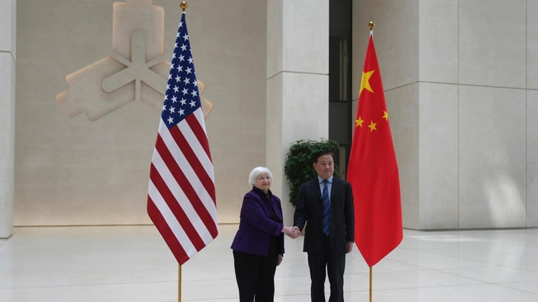 U.S. Treasury Secretary Janet Yellen, left, shakes hands with Governor...