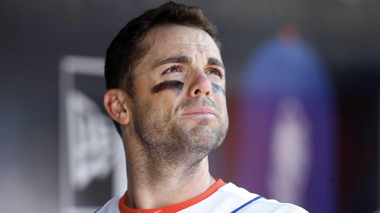 David Wright looks on from the dugout late in a...