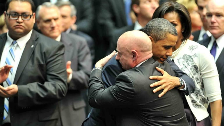 President Barack Obama hugs NASA astronaut Mark Kelly, husband of...