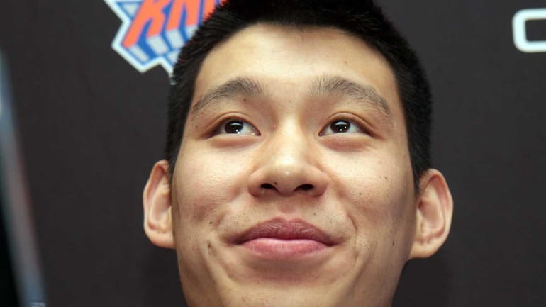 Injured Knicks point guard Jeremy Lin talks to the media...