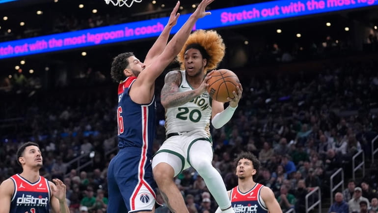 Boston Celtics guard JD Davison (20) drives toward the basket...
