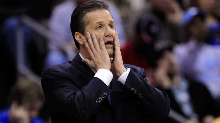 John Calipari, head coach of the Kentucky Wildcats, reacts after...