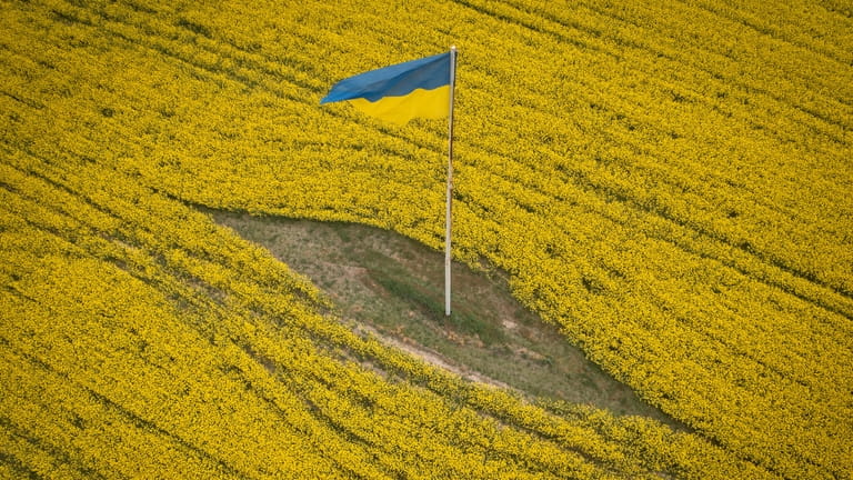 A Ukrainian national flag flutters in the middle of a...