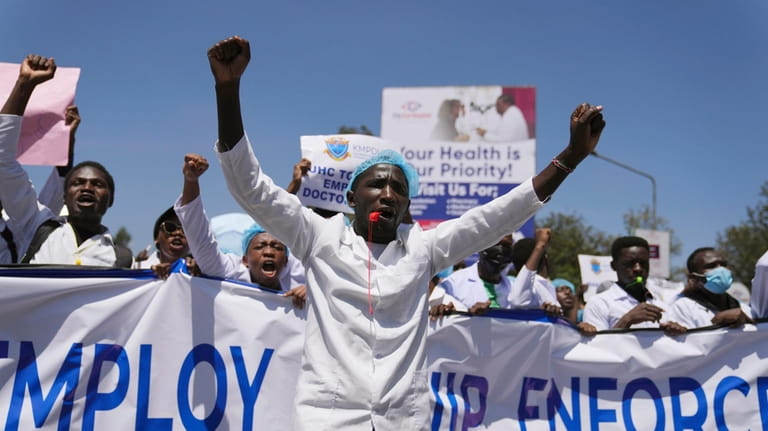 Doctors and other medical staff take part in a protest,...