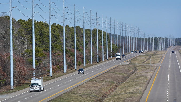 PSEG Long Island’s tall steel utility poles line the southbound...