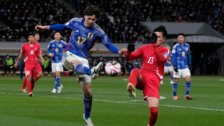 North Korea's Ri Il Song, right, competes for the ball...