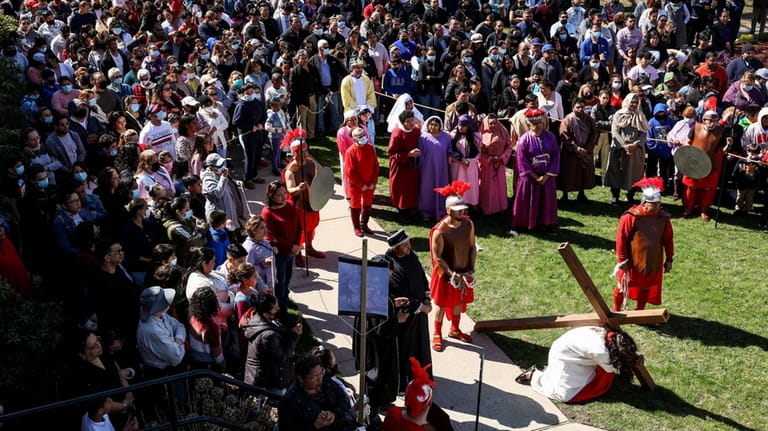 Hundreds watch the re-enactment of the Stations of the Cross in...
