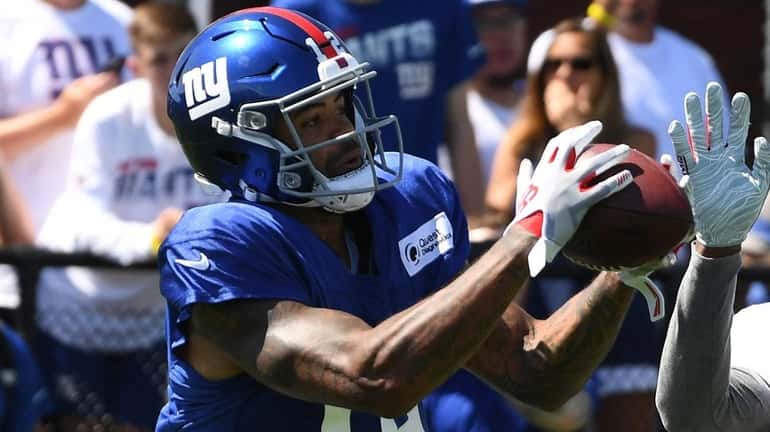 Giants wide receiver Cody Latimer catches a pass as defensive...