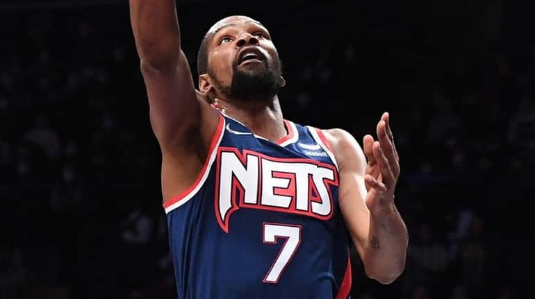 Nets forward Kevin Durant scores a layup as Clippers forward...