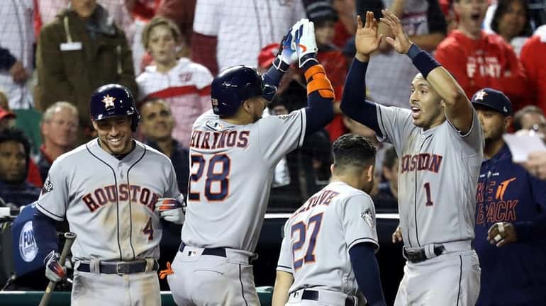 Robinson Chirinos #28 of the Houston Astros is congratulated by...